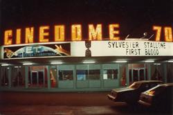 The marquee of the Cindeome 70 at night, with 'E. T.: The Extra-Terrestrial' and 'First Blood'.